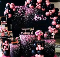 black and pink balloons are on display in front of a backdrop that says asta