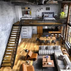 an aerial view of a living room, kitchen and dining area with stairs leading up to the second floor