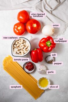 ingredients to make pasta laid out on top of a sheet of paper, including tomatoes, cashews, garlic, and mushrooms