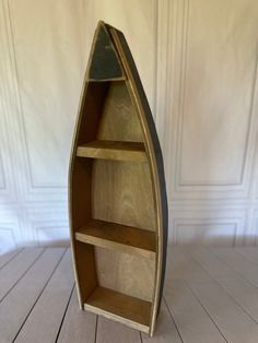 Wooden three shelf boat unit. Stained natural wood accents with a black distressed exterior base. Measures 24”H x 8”W x 3”D Canoe Bookshelf, Boat Shelf Decor, Row Boat Shelf, Canoe Shelf, Saree Boutique, Boat Shelf, Natural Wood Accents, Wood Boats, Nursery Room Inspiration