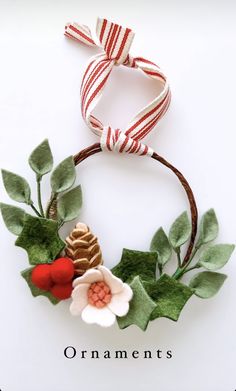 an ornament with leaves, flowers and a pine cone