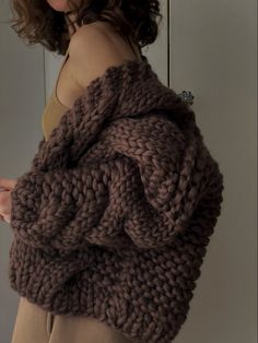 a woman wearing a brown knitted sweater