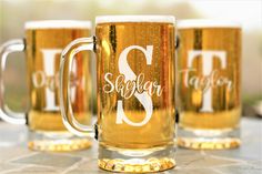 three beer mugs sitting on top of a metal tray