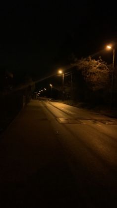 an empty road at night with street lights