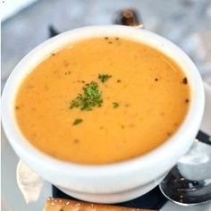 a white bowl filled with soup on top of a table