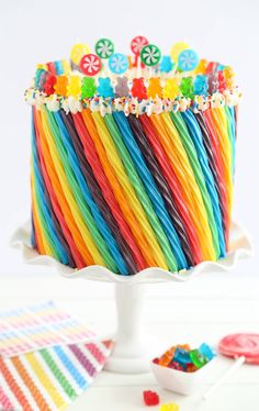 a rainbow cake with lots of candies on top