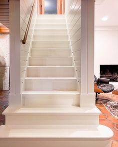 there is a set of white stairs leading up to the second floor in this house