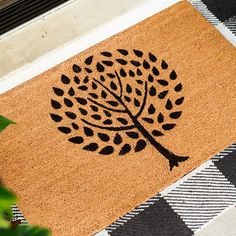 a door mat with a tree drawn on it