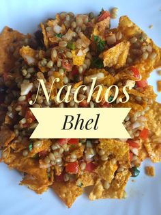 nachos with corn and tomatoes on a plate that says nachos bhel