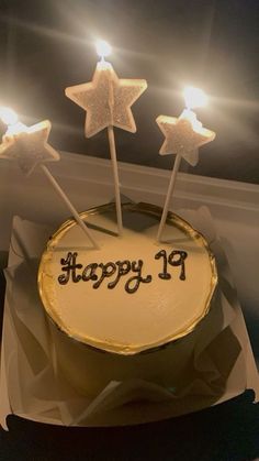 a birthday cake with white frosting and three stars on top that say happy 19