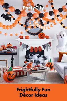 a living room decorated for halloween with balloons and pumpkins hanging from the ceiling,