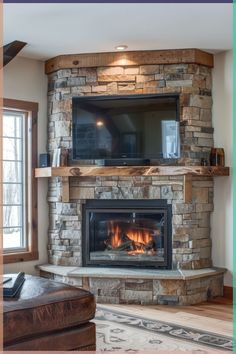 a living room with a stone fireplace and flat screen tv mounted above it's mantle