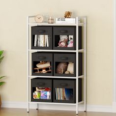 a white shelf with black bins filled with books