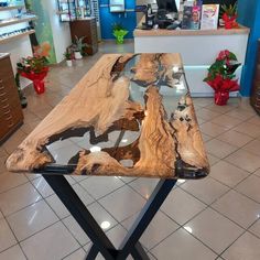 a wooden table sitting on top of a tiled floor