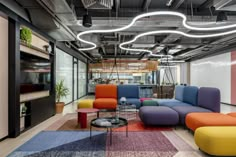 an office with multicolored couches and tables