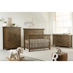 a baby's room with two dressers, a rocking horse and a crib