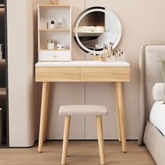 a bedroom with a vanity table and stool in front of the mirror on the wall