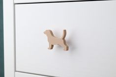 a wooden toy dog mounted to a white cabinet