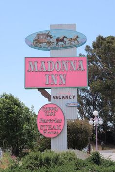 the sign for madonna inn in vacany is pink and has horses on it