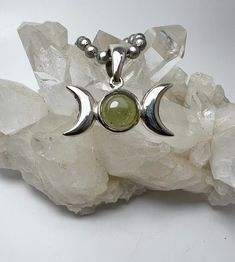 Triple Moon Goddess,#473, MOLDAVITE, Medium size, Pendant, 8mm AA, Stone, Pendant, P109.8mm,#473 BOX#3 The stone is 8mm. The distance from crescent point to the opposite crescent point is about 7/8" / 22 mm.  The height  is about 3/4" including bail.  The silver is polished to a mirror finish front and back.   All stones are hammer set. We design jewelry to last lifetime. This pendant comes with a complementary stainless steel chain. please choose your preferred length.  Thank you for considering my work. Luvbruce Triple Moon Necklace, Green Amulet Pendant Jewelry, Handmade Moon-shaped Amulet Jewelry, Green Amulet Pendant Crystal Necklace, Moldavite Pendant, Triple Moon Goddess, Triple Moon, Moon Goddess, Design Jewelry