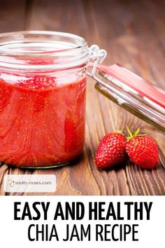 two strawberries sit next to a jar of jam on a wooden table with the words easy and healthy chia jam recipe