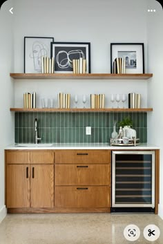 a kitchen with wooden cabinets and shelves filled with wine glasses