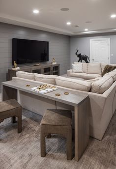 a living room filled with furniture and a flat screen tv mounted to the side of a wall