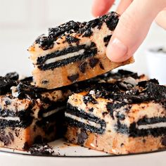 someone is picking up some oreo cake from the plate