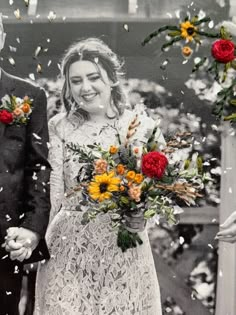 a man and woman standing next to each other with flowers in front of their faces