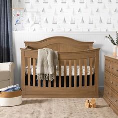 a baby's room with a crib and dresser