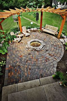 an outdoor fire pit surrounded by wooden benches