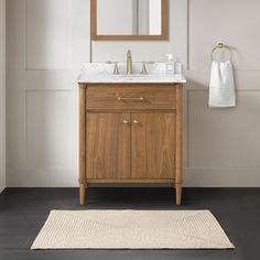 a bathroom with a sink, mirror and rug