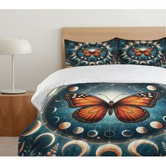 a bed with an orange butterfly on it