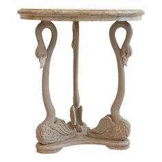 a small table with two flamingos on it's legs and an oval top