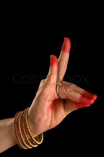 a woman's hand with red nail polish and bracelets holding up the peace sign