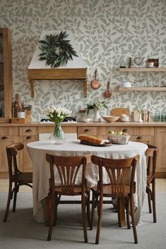 a dining room table with four chairs around it