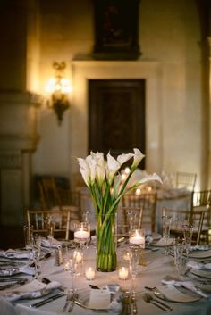 there is a vase with white flowers on the table