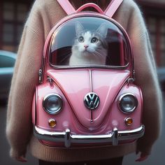 a woman holding a pink vw bug with a cat in it