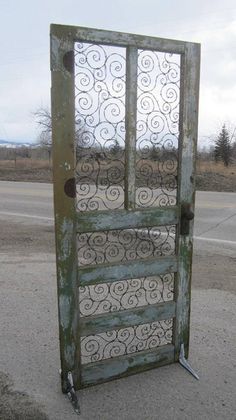 an old door is sitting on the side of the road