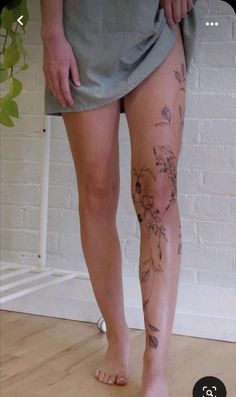 a woman's legs with tattoos on them