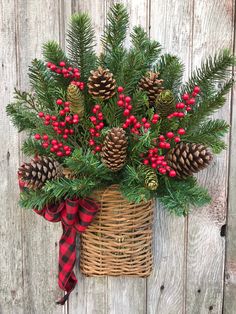 a basket filled with pine cones and red berries