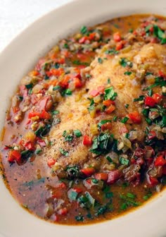 a white bowl filled with meat and vegetables