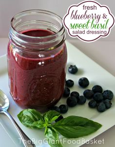 fresh blueberry and sweet basil salad dressing in a jar with spoons on the side