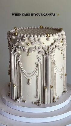 a white cake sitting on top of a three tiered cake stand with the words, when cake is your canvas