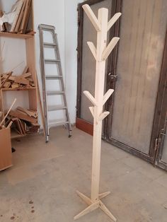 a tall wooden tree is in the middle of a room with boxes and ladders