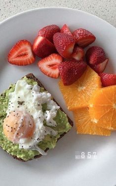 an egg, toast and fruit on a white plate