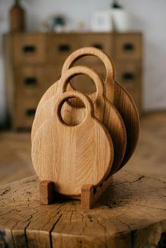 three wooden cutting boards stacked on top of each other