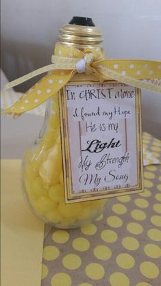 a glass jar filled with yellow candies on top of a polka dot table cloth