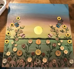 a painting with sunflowers and buttons on it