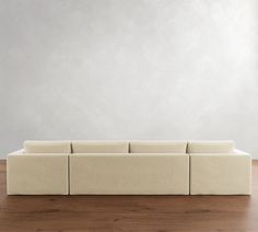 a white couch sitting on top of a wooden floor